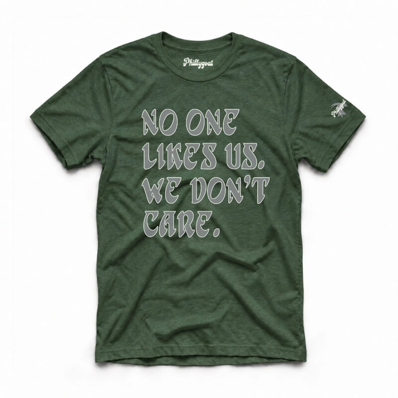 A dark green crewneck t-shirt with the text 'NO ONE LIKES US, WE DON'T CARE.' printed in a gray gothic font on the front.