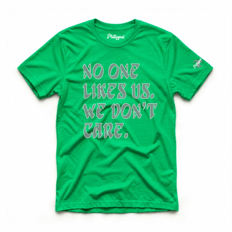 A bright green short-sleeve t-shirt with the text 'NO ONE LIKES US, WE DON'T CARE.' printed on the front in a stylized gray and white font.