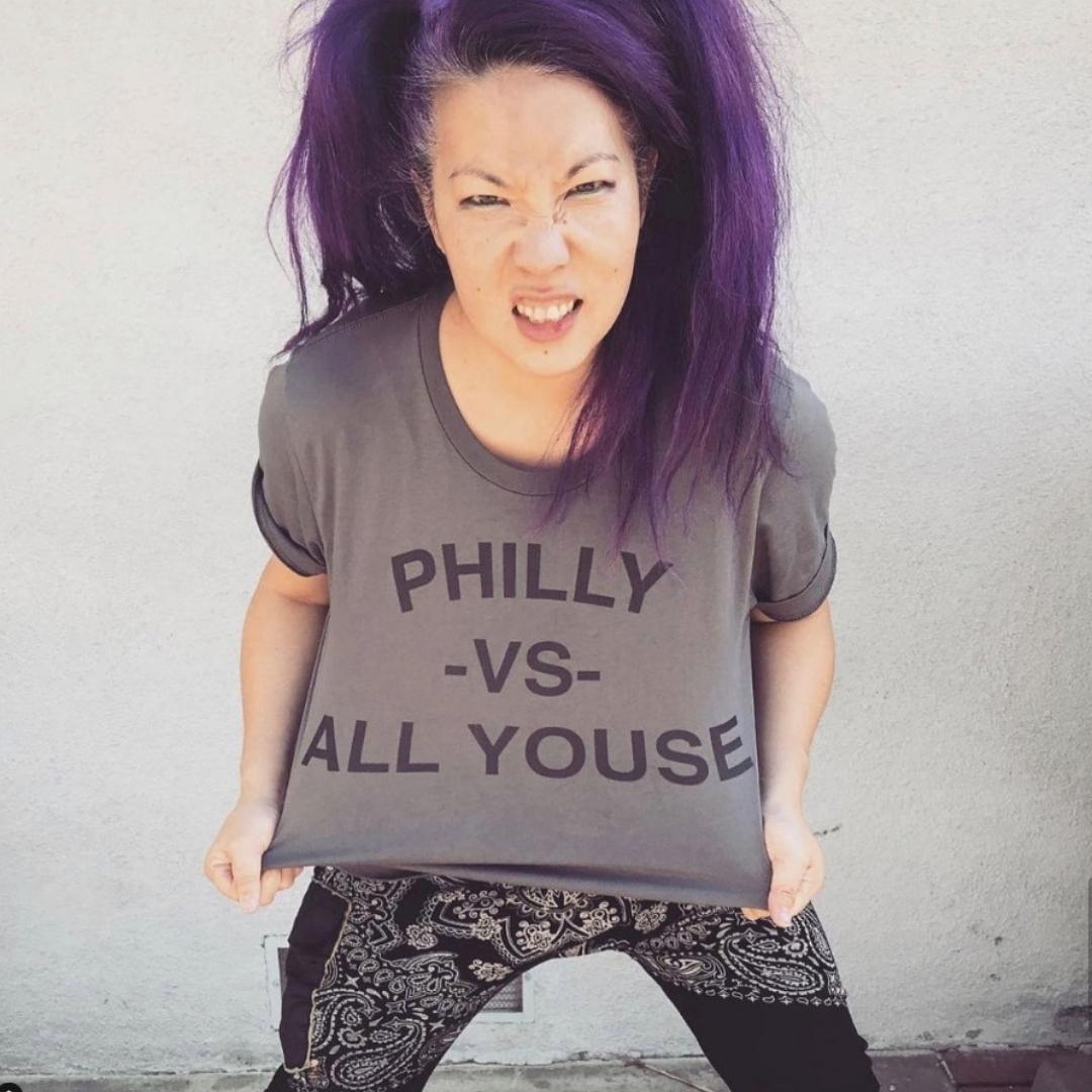 Asian lady wearing a funny Philly vs All Youse shirt from Phillygoat