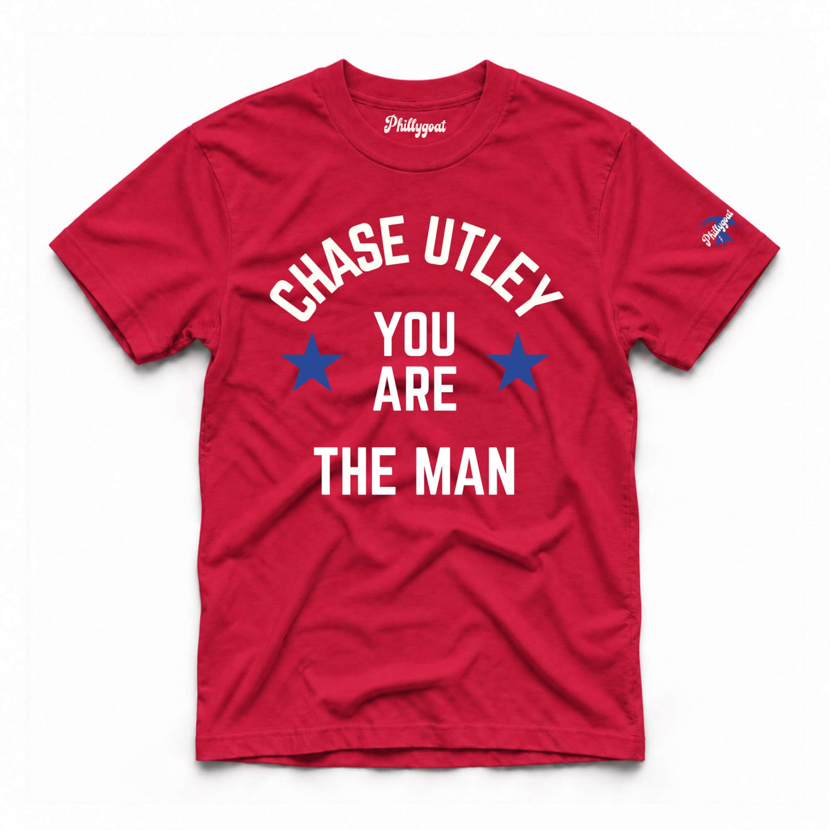 A red short-sleeve t-shirt with a graphic print that reads 'CHASE UTLEY YOU ARE THE MAN' in white text with blue stars, shown flat on a white background.