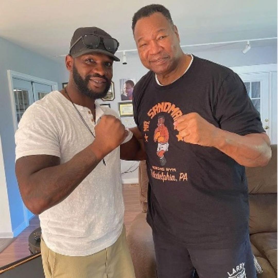 Larry Holmes wearing a Phillygoat Philadelphia Boxing Club Mr. Sandman shirt