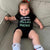 Philadelphia Eagles baby fan wearing a funny baby onesie from Phillygoat that says Dallas Sucks